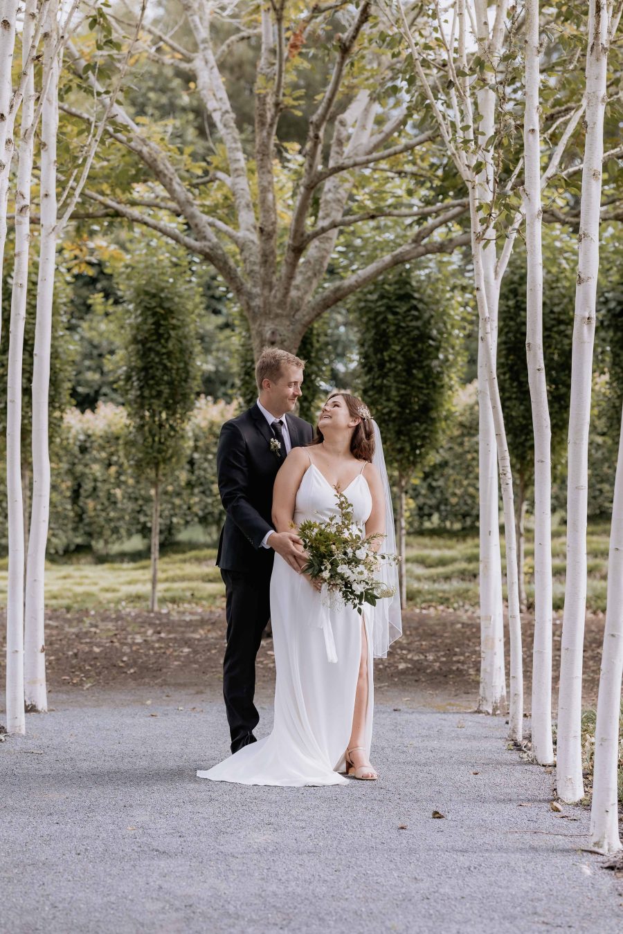 Happy bride and Groom Tree church pathway