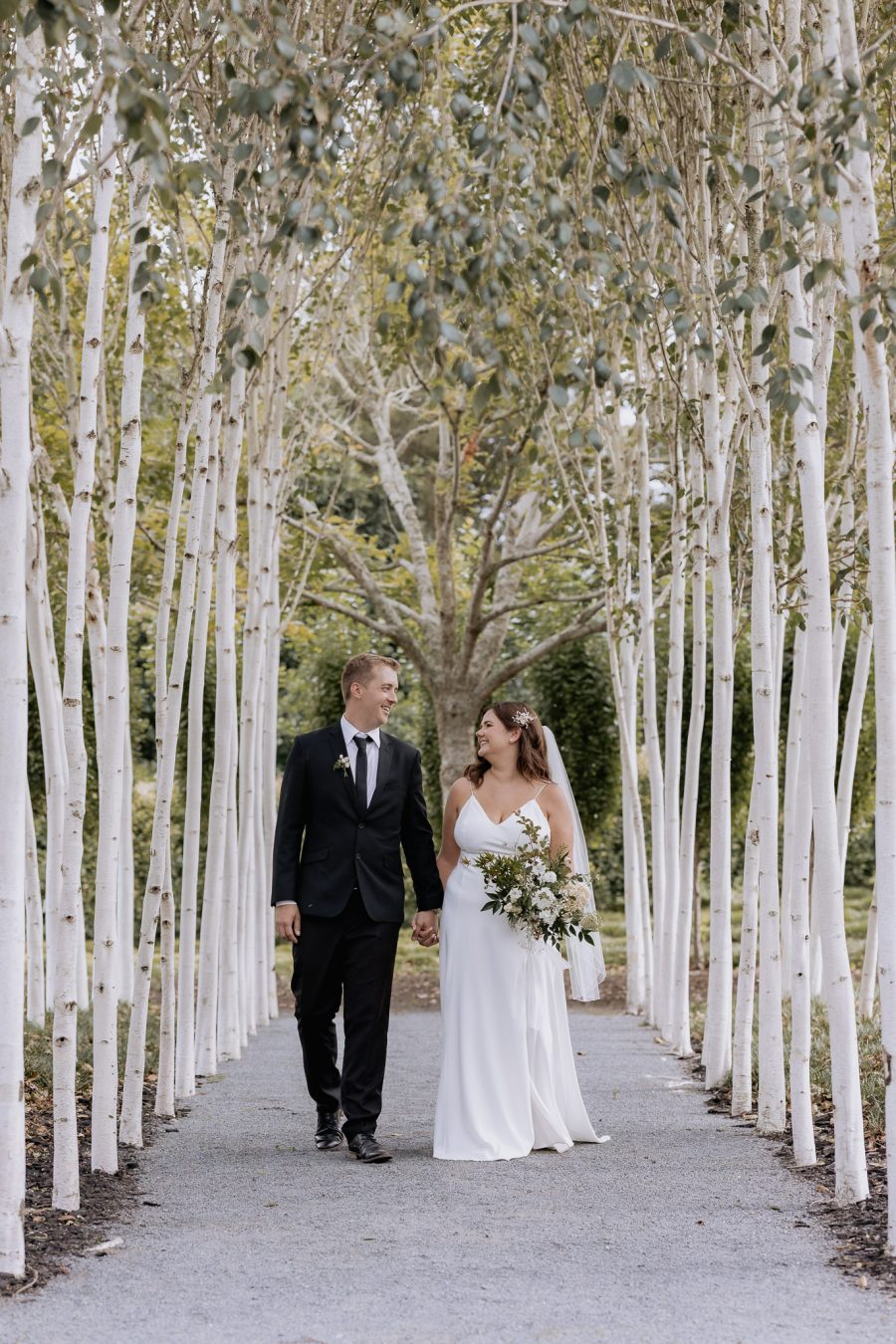 Wedding couple walking Waikato Tree Church