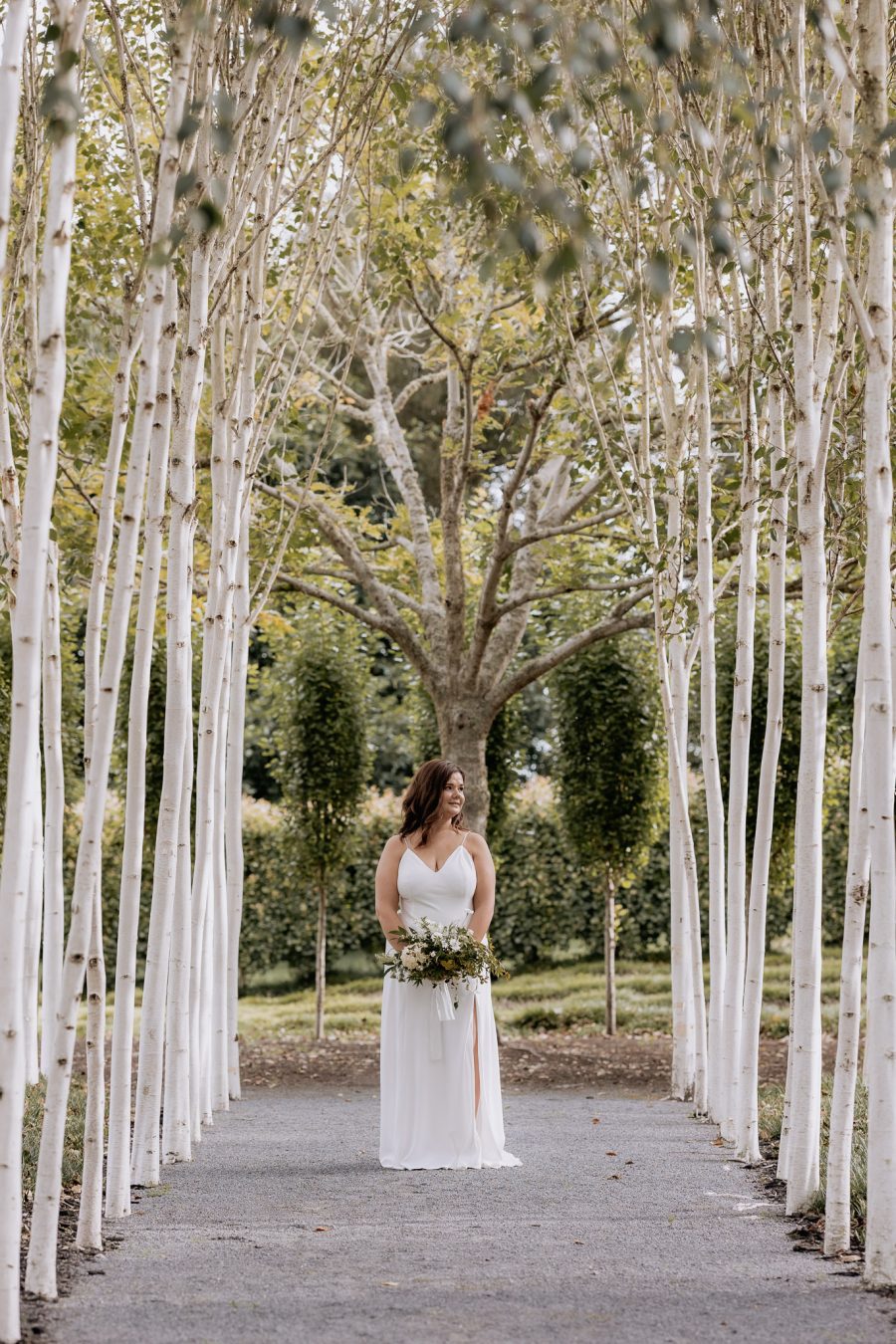 Bride on own in path at Tree Church gardens