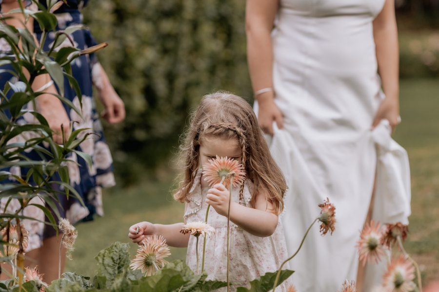 Little girl smells flower garden Ohaupo wedding venue