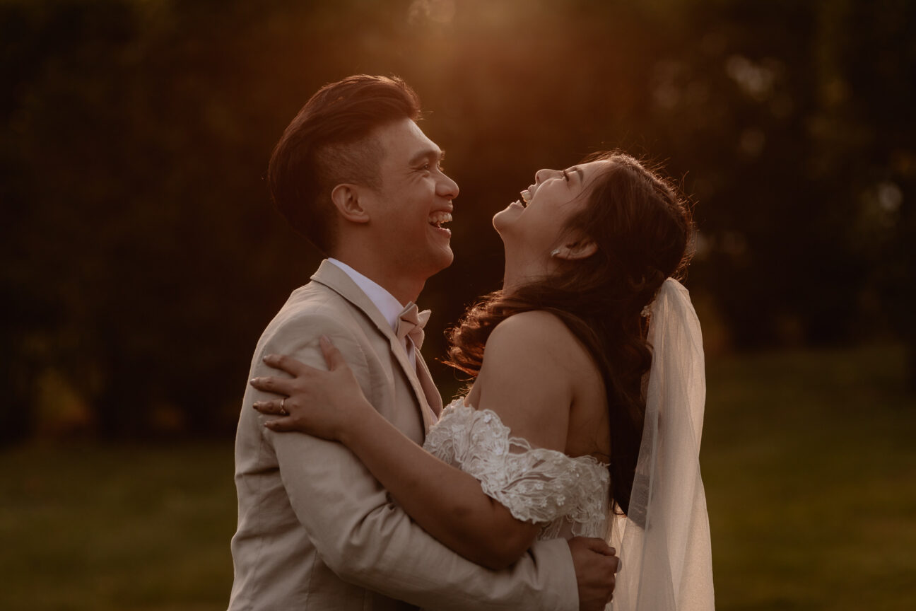 Bride and groom laughing at Ataahua garden wedding