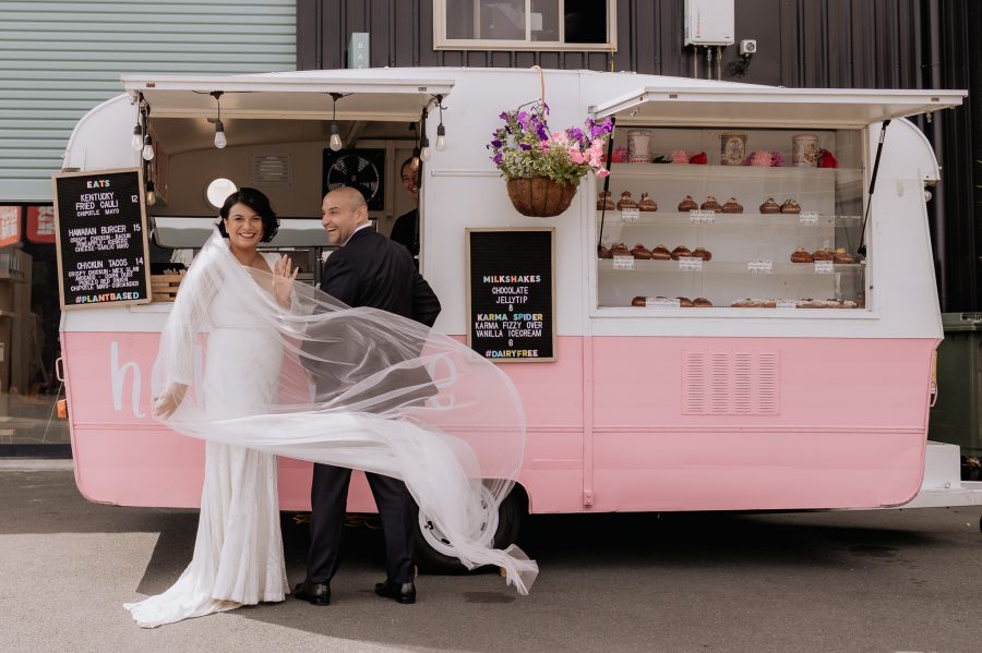 Pink doughnut caravan with bride and groom