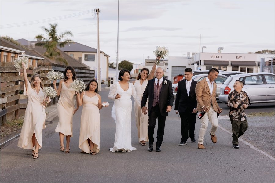 wedding party walking behind fife lane blush bridesmaids