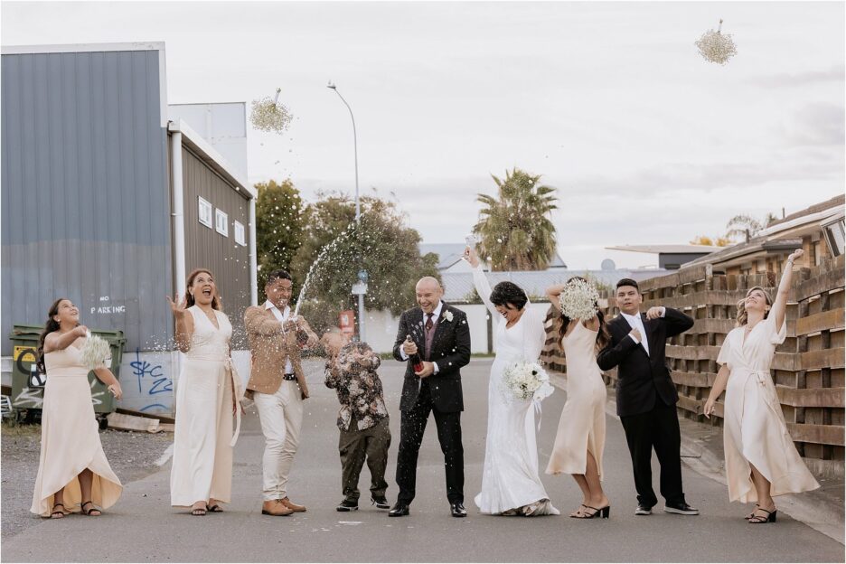 popping open bubbles with wedding party on Fife lane