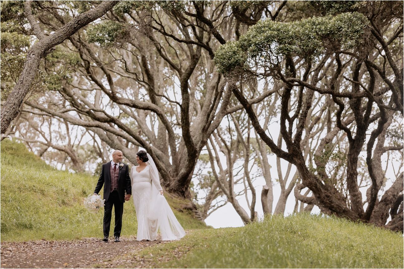Bride and groom walking on path on Mount Drury