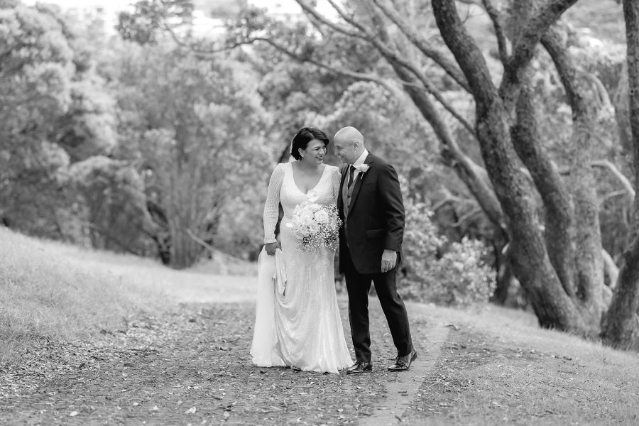 Canid moments with bride and groom walking up path