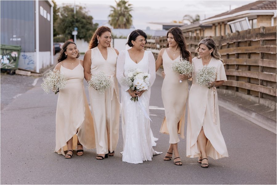 Kwh bride walking with blak bridesmaids dresses in blush pink