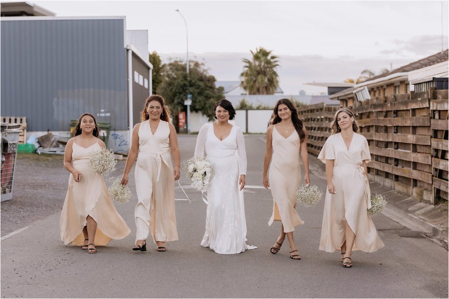 Bride with bridesmaids blak dresses in blush pink on Fife land mount maunganui wedding