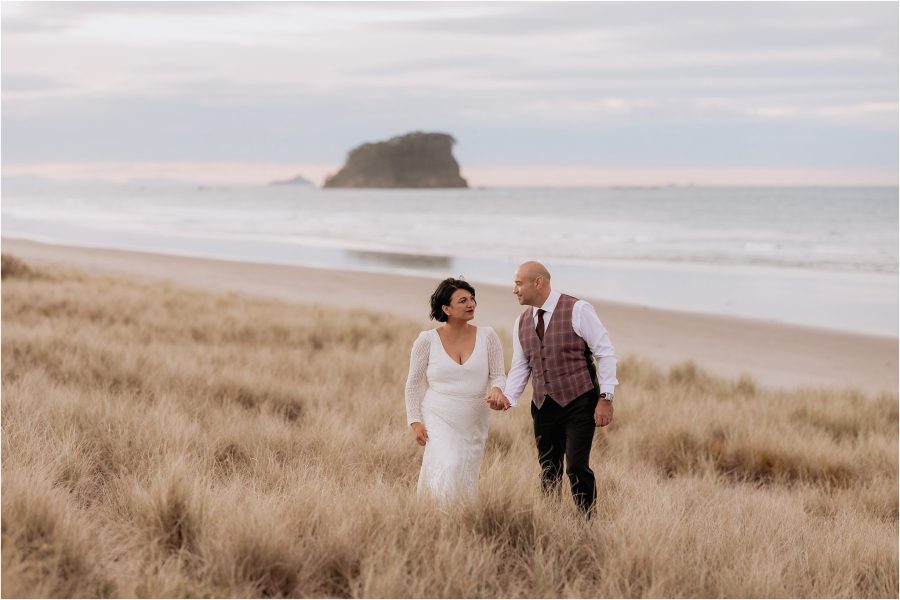 Pure Images Photography with wedding photos of couple on sand dunes New Zealand