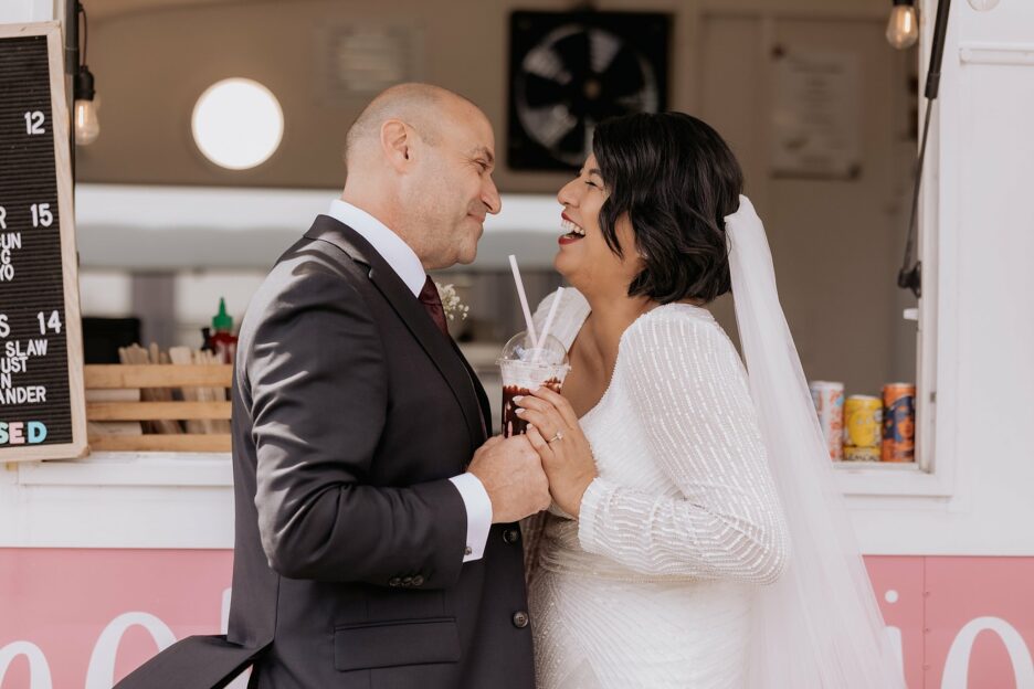 Wedding couple laughing over sharing icecream sundae