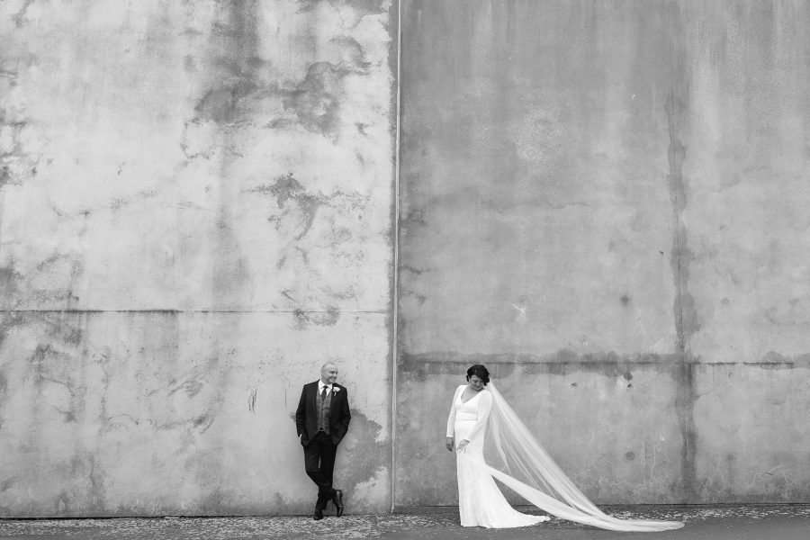 Wedding couple concrete wall