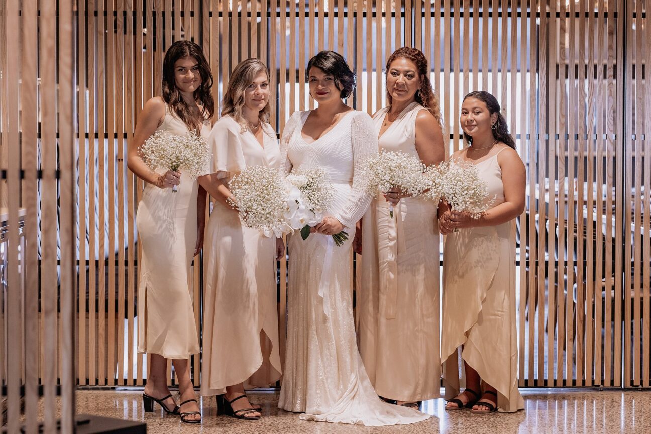 Bride with bridesmaids in their blush pink blak dresses