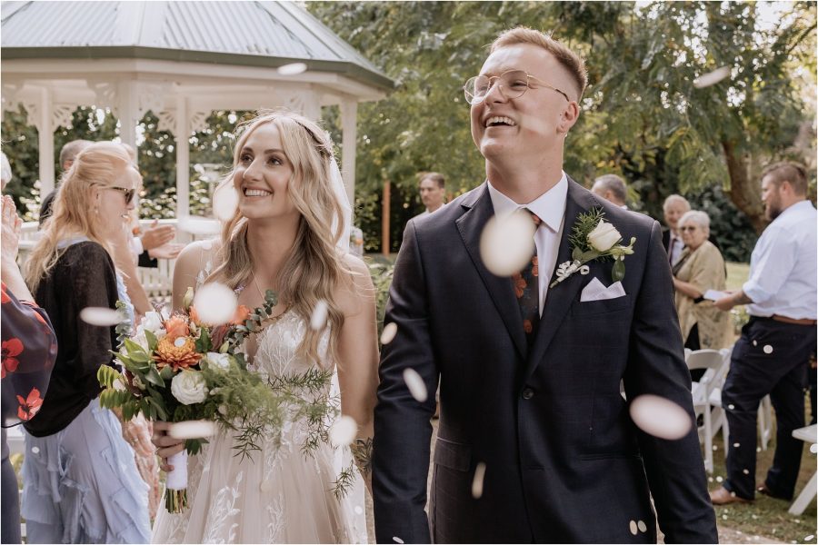 just married confetti thrown at bride and groom