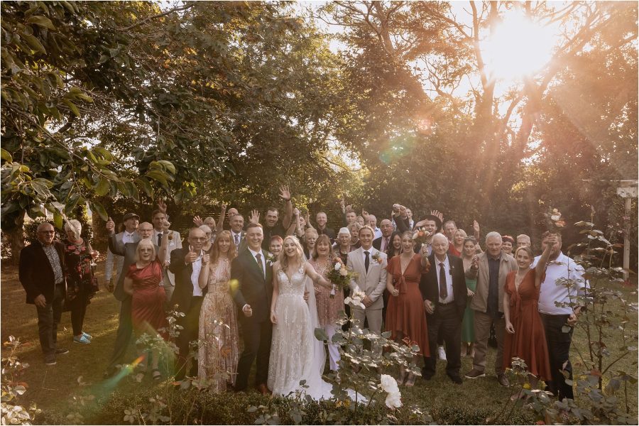 wedding guests throwing hands up waving happy