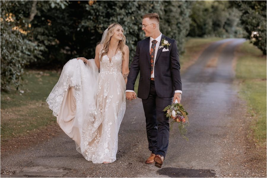 walking on country lane wedding couple