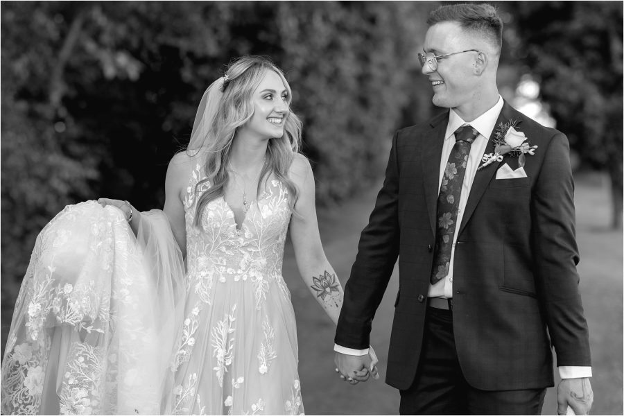 bride looks at groom in black and white photo