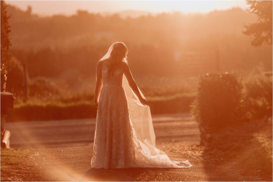 Bride on her own bathed in golden autumn sunshine light