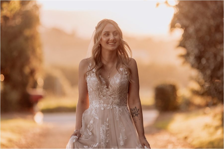 Happy relaxed brdie walking madi lane wedding dress