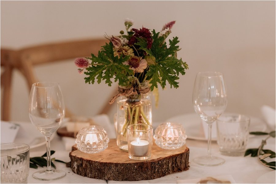 Flowers lit by candles at reception tables