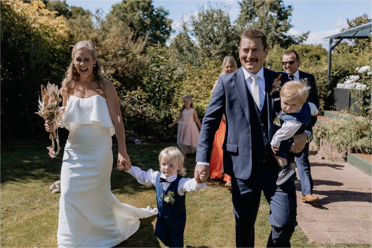 Just married couple walking with kids