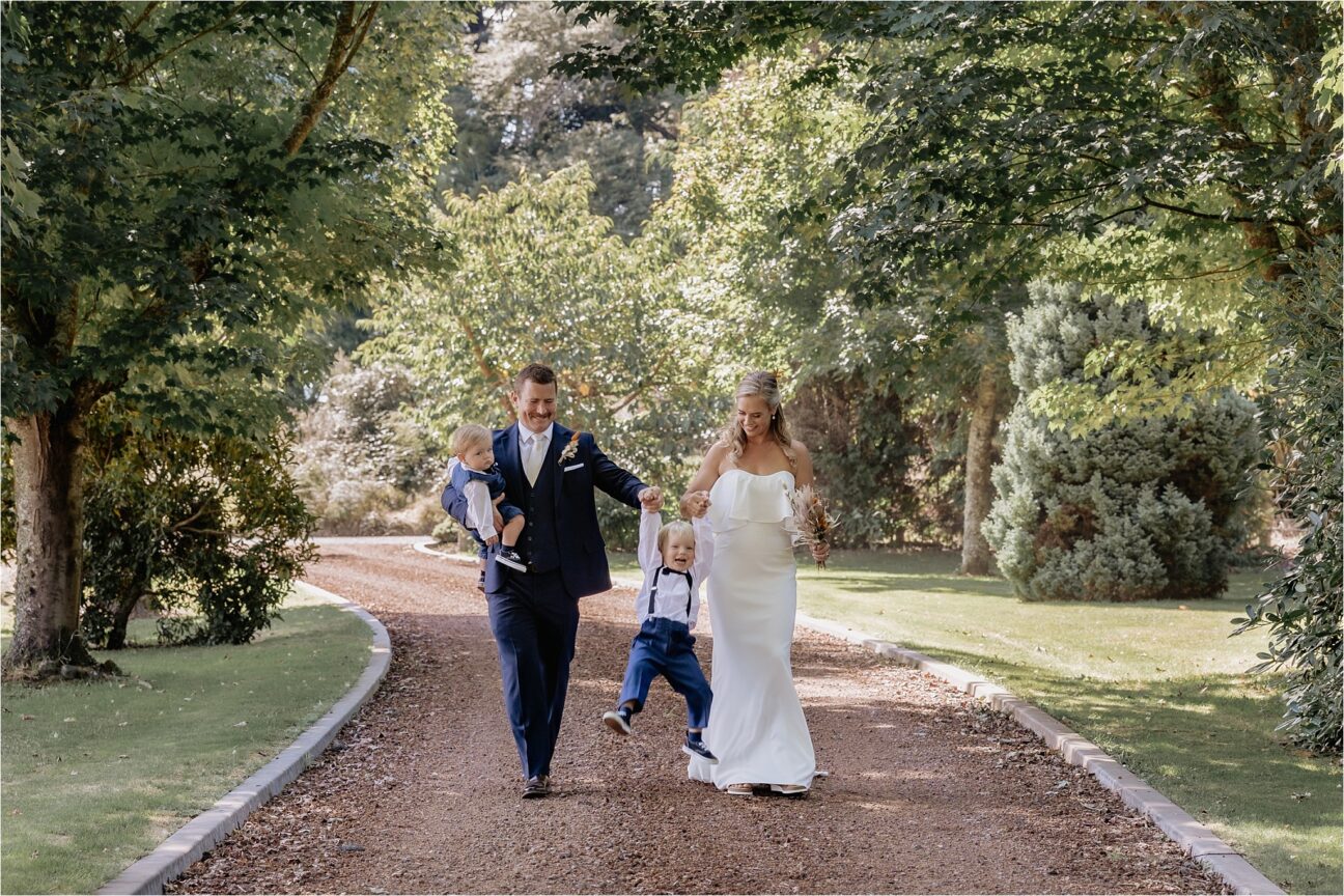 Family photos on driveway, Mum and Dad lifting son laughing