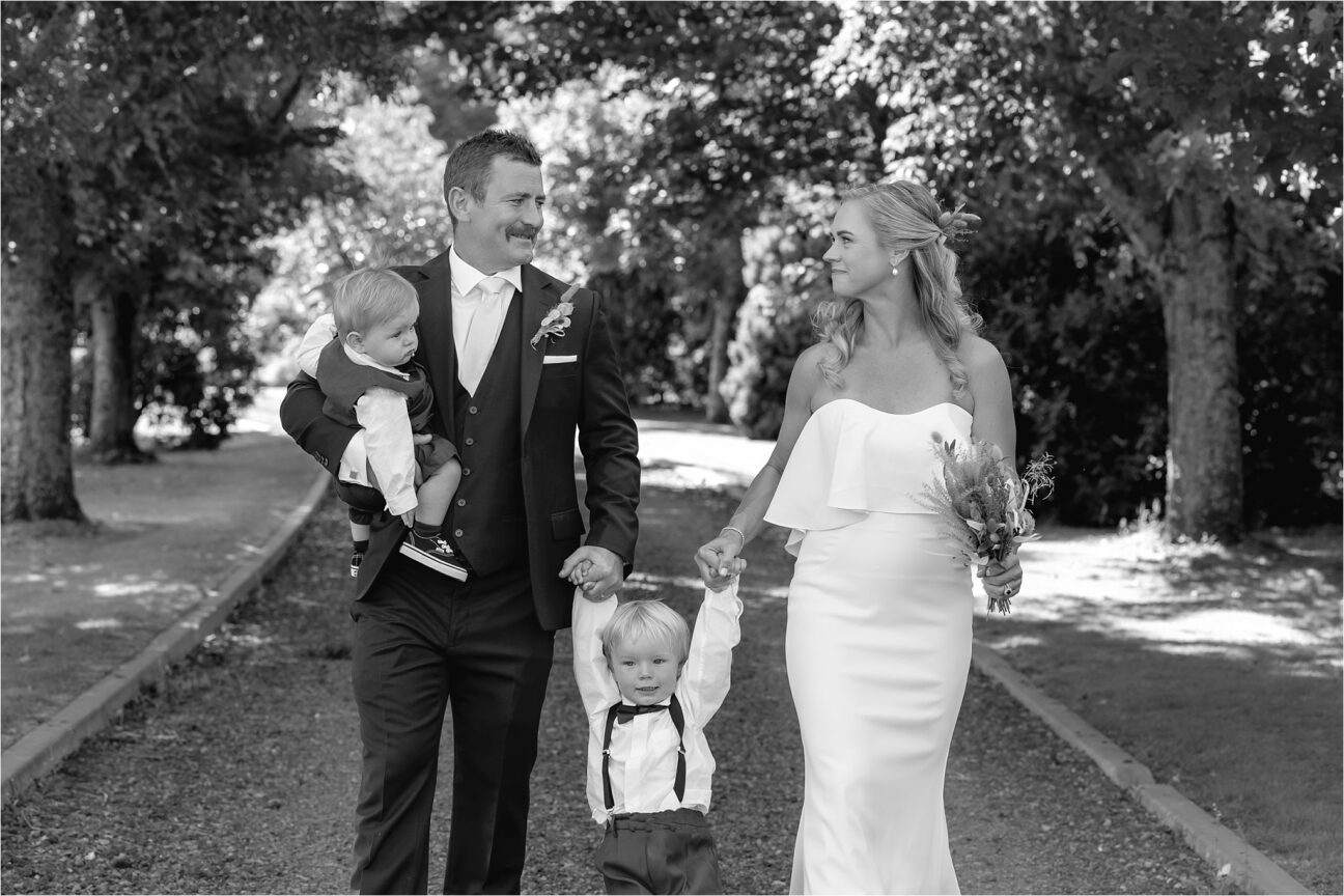 Happy family photo taken in driveway of backyard farm wedding in Ohakune Manawatu New Zealand