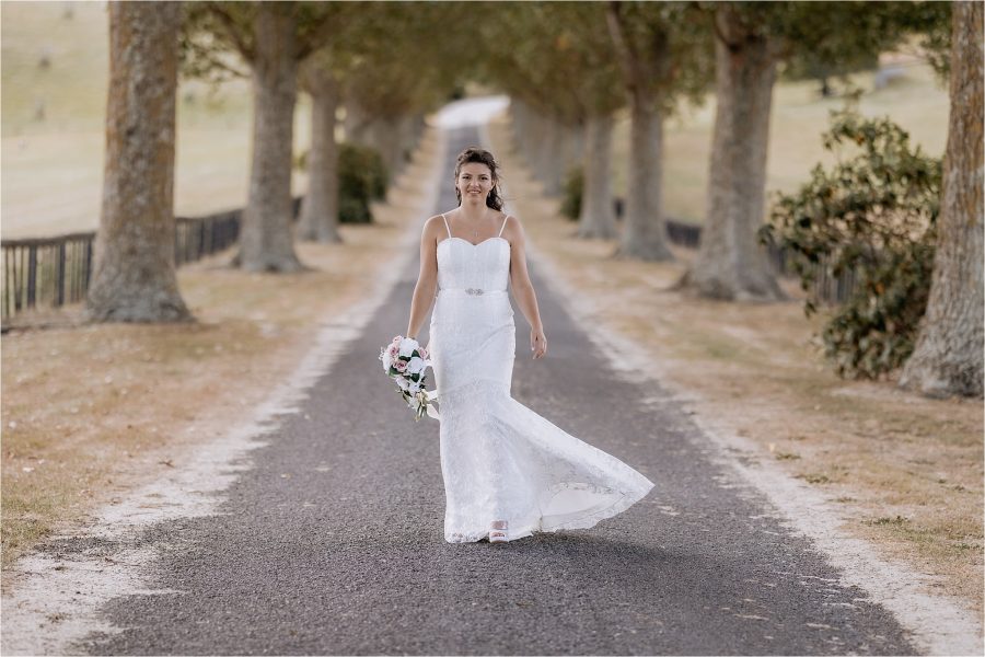 Confident bride walking along redbarns driveway