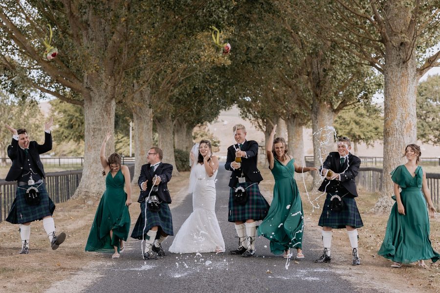 wedding party spraying champagne everyone laughing having fun