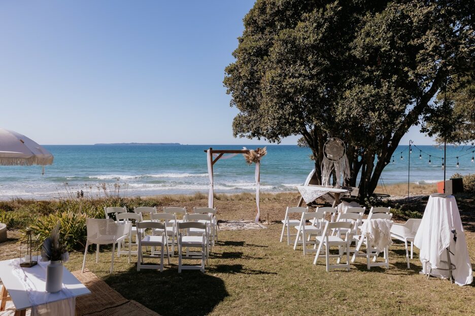 Papamoa Beach front lawn set up for back yard wedding with arch and seating