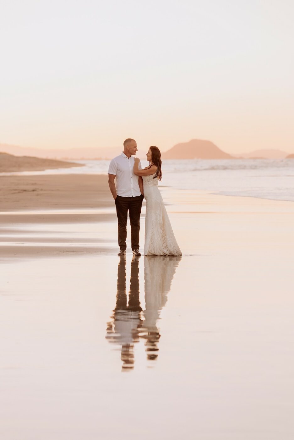 beach wedding photography with reflections in water