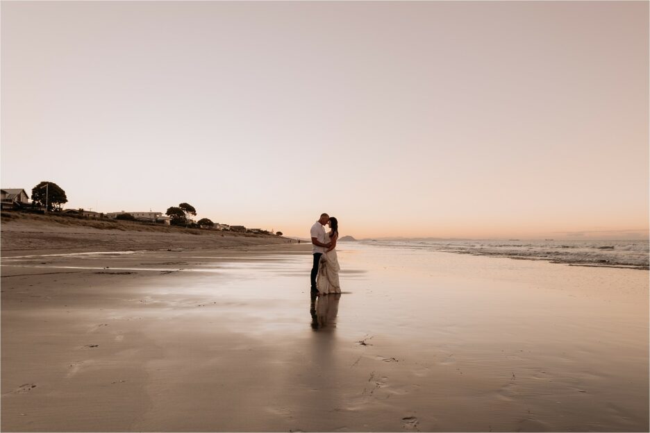 wedding couple kissing on Papamoa Beach