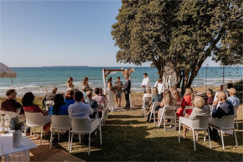 Wedding ceremony in progress at beach house Papamoa