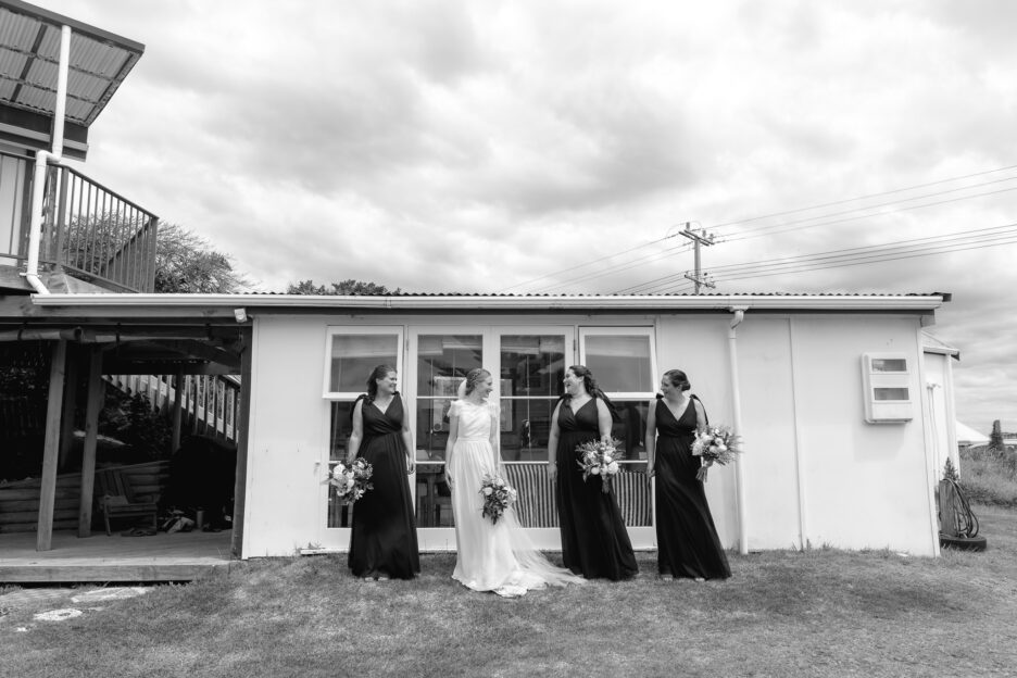 Bride with bridesmaids old Kiwi bach Pongakawa beach