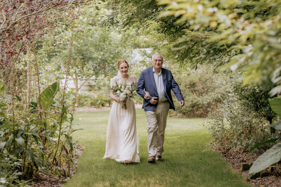 Bride walks aisle with father at Old Forest School