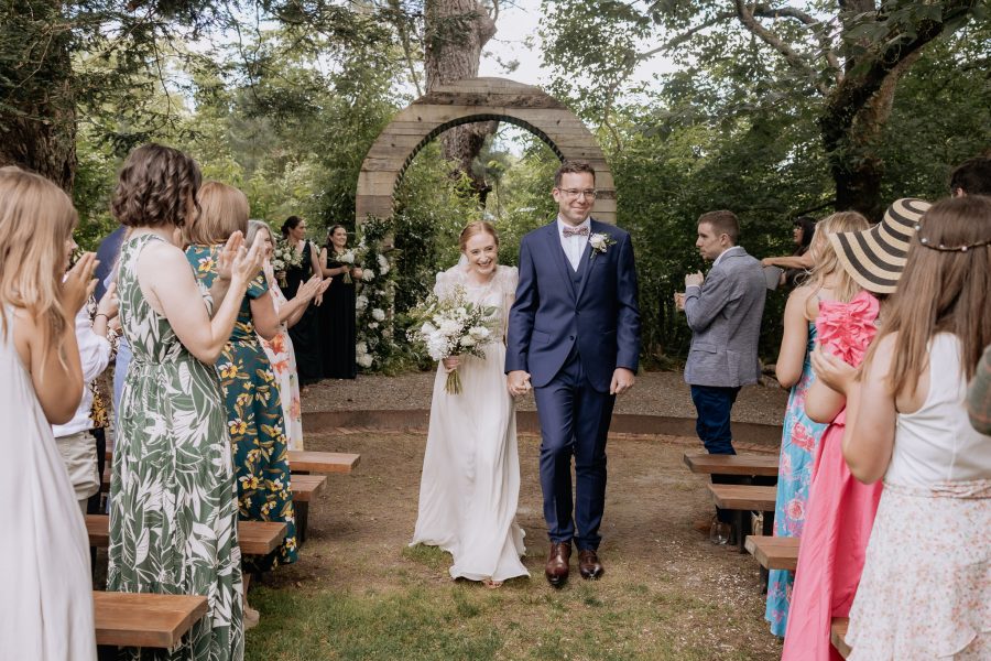 Bride and groom walk down aisle at Old Forest School with Pure Images Photography