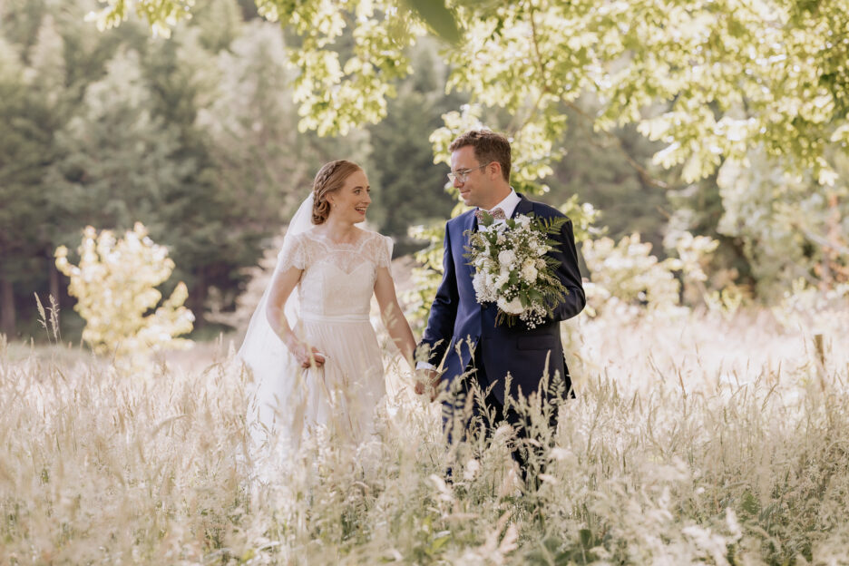 Wedding photos at Old Forest School walking under oak tree