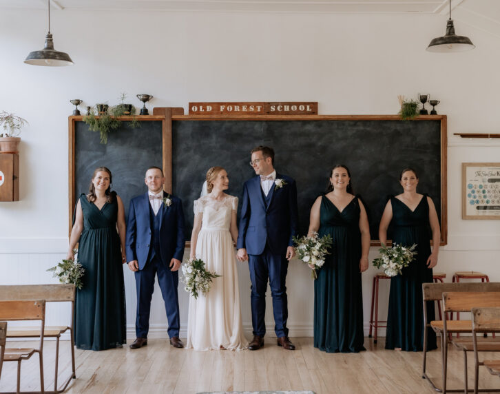 Wedding party inside school room at Old Forest School