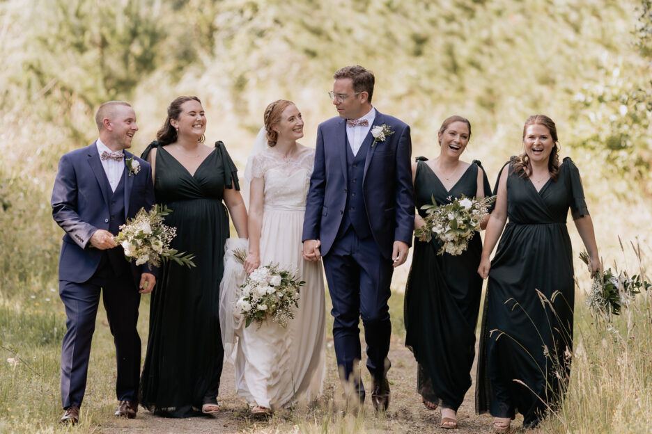 Walking bridal party in green dresses walking in country Old Forest School Wedding