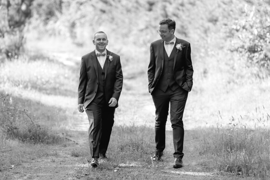 Groom and best man walking on country lane New Zealand Wedding