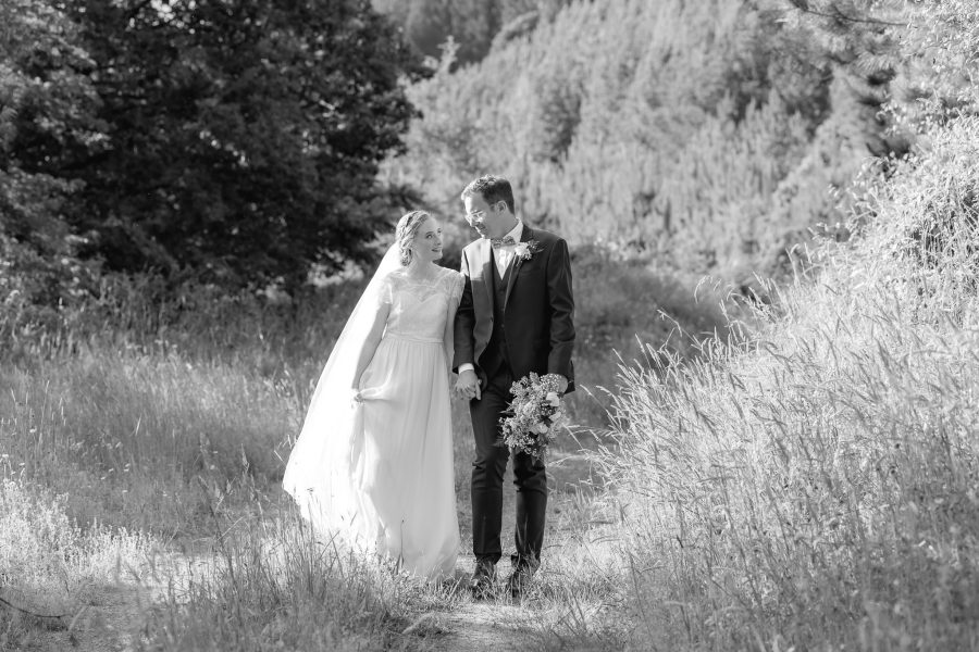 lovely moment at wedding couple look at each other in love in forest