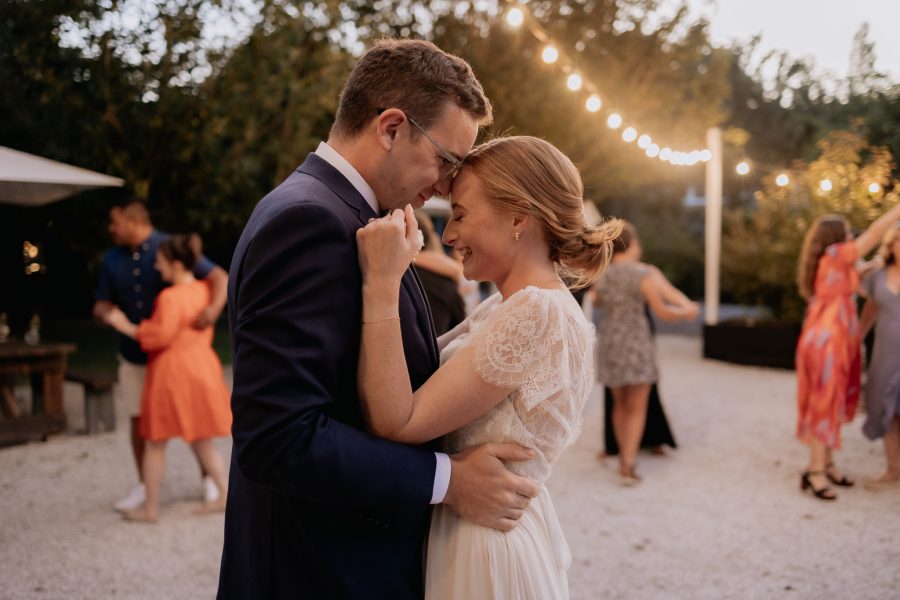 Wedding couple dancing under the stars at old forest school