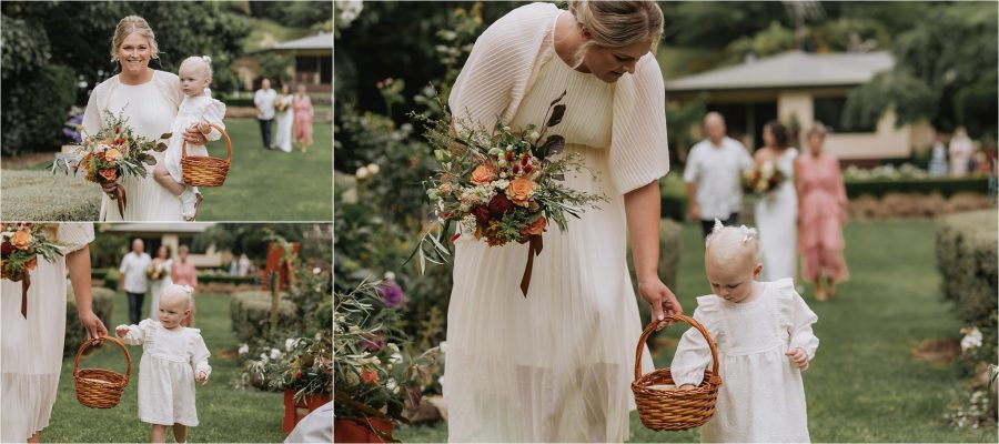 Bridesmaid walking with flower girl down aisle