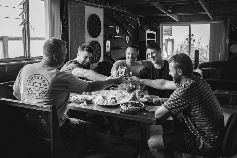 Groomsmen having beers before ceremony in mens shed