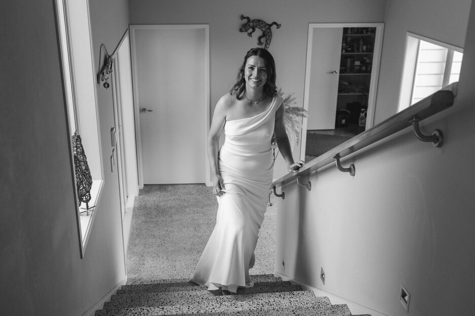 Bride climbing stairs before first look