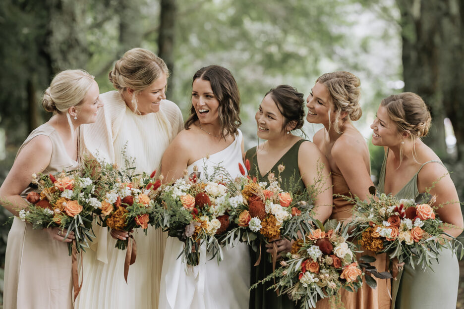 Autumn mixed country bridesmaids having fun during photography session at The Run Matata