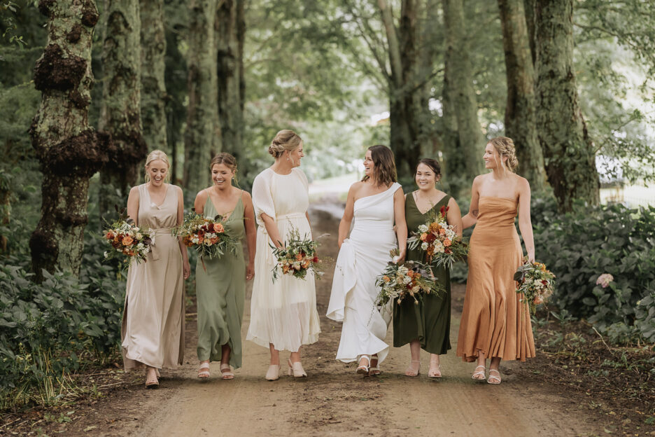 Bride with bridesmaids in the driveway at the Run Whakatane wedding ceremony