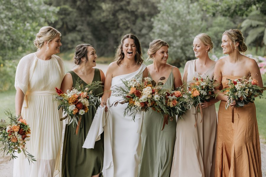 Bride laughing at her bridesmaids