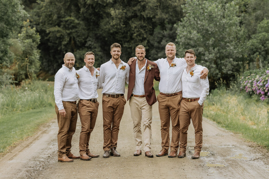 groom with his groomsmen on country road