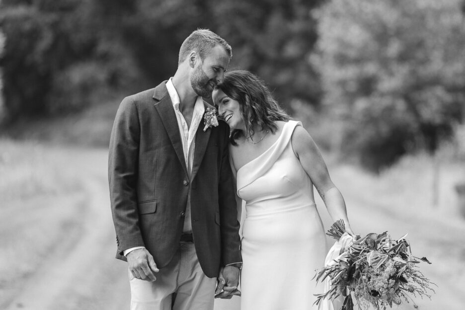 Bride leans on groom during photography at the Run Matata