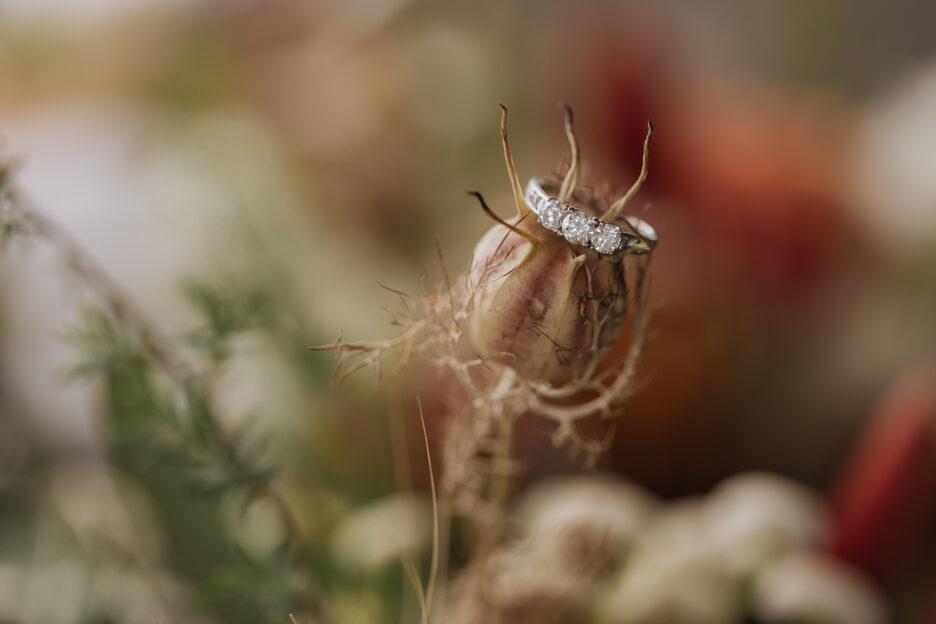 Wedding ring sitting on top of flower